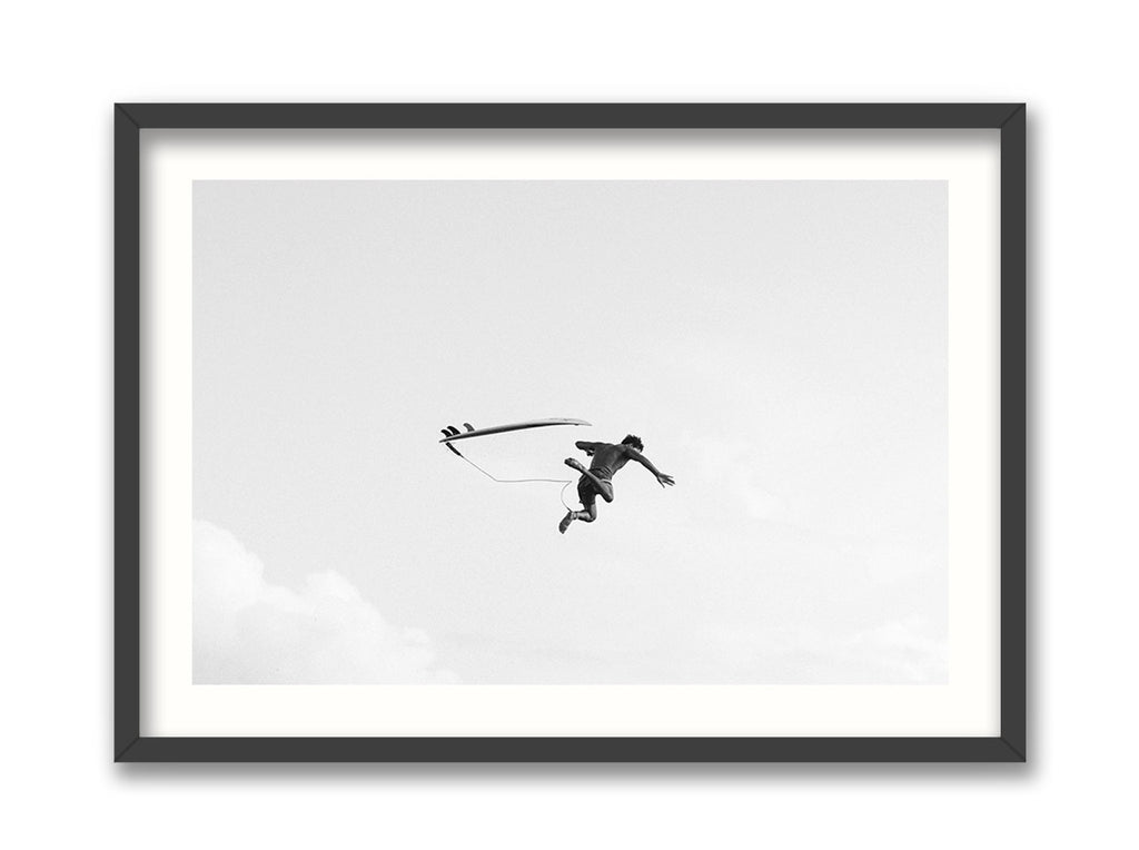Framed black and white photograph of a surfer in mid-air